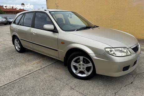 Gold 2003 Mazda 323 Hatchback Astina Shades