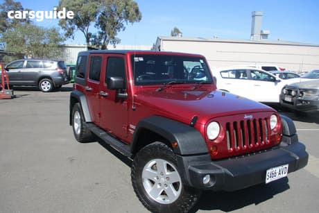 Red 2012 Jeep Wrangler Softtop Unlimited Sport (4X4)