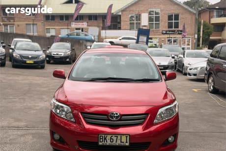 Red 2009 Toyota Corolla Sedan Conquest