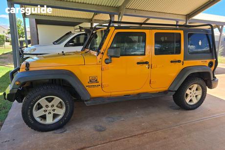 Orange 2012 Jeep Wrangler Softtop Unlimited Sport (4X4)