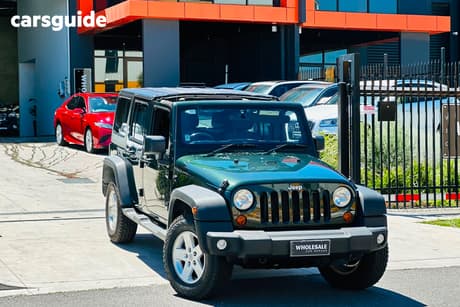 Green 2011 Jeep Wrangler Softtop Unlimited Sport (4X4)