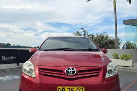 Red 2010 Toyota Corolla Hatchback Conquest