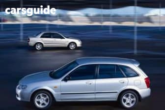 Silver 2003 Mazda 323 Sedan Protege Shades