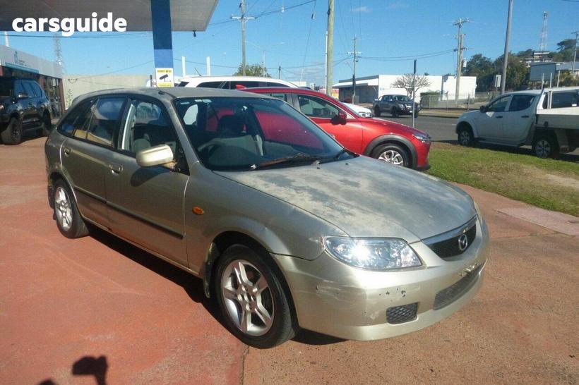 Gold 2003 Mazda 323 Hatchback Astina Shades